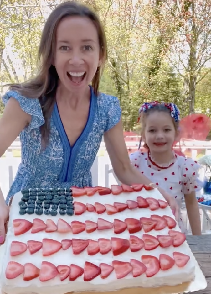 Shannon and her daughter show off their American Flag Charcuterie Board from her blog Fun Food Hacks For Celebrating the Fourth Of July!